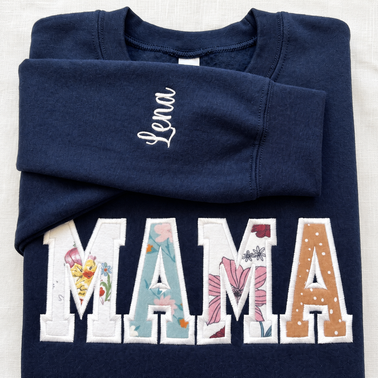 Single embroidered sleeve name on a MAMA keepsake sweatshirt
