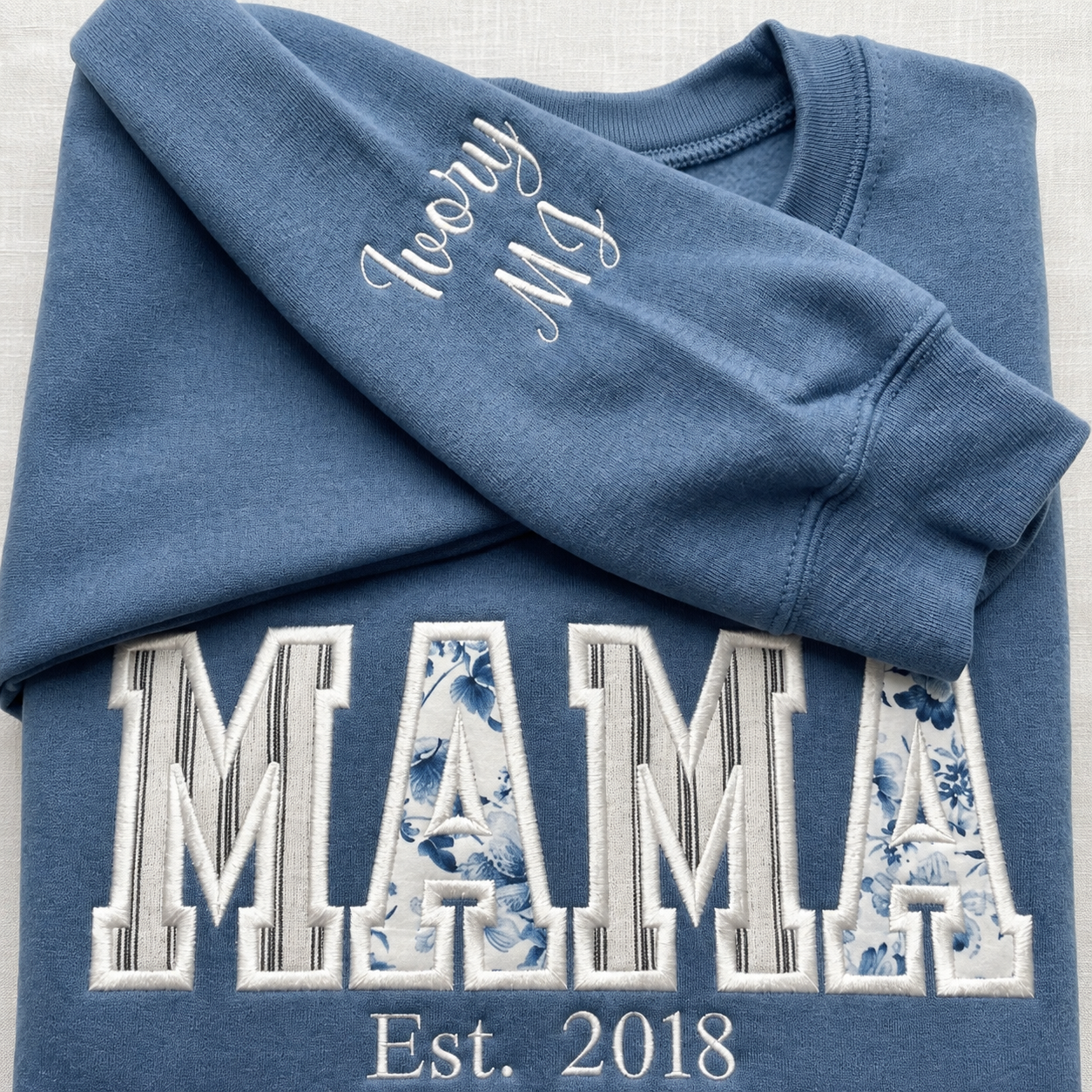 Personalized embroidered names on a MAMA sweatshirt sleeve